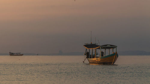 Koh rong island, cambodia at sunrise. strong vibrant colors, boats and ocean