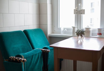 Chairs and wooden table by window