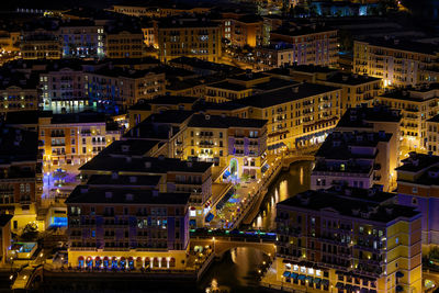 High angle view of illuminated buildings in city at night