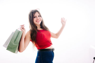 Portrait of a smiling young woman against white background