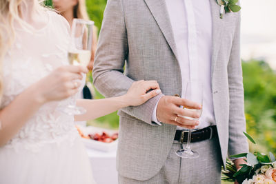 Midsection of couple having champagne
