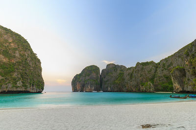 Scenic view of sea and mountains against sky