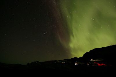 Scenic view of silhouette mountain against sky at night