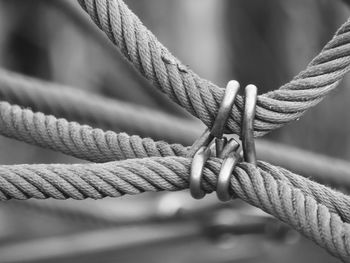 Close-up of ropes tied with hooks outdoors