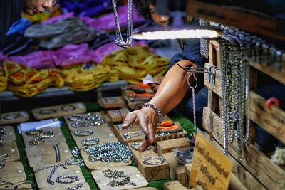 Man selling jewelry at market during night