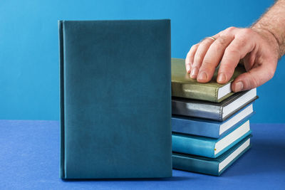 Close-up of hand on book