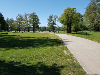 Footpath in park against sky