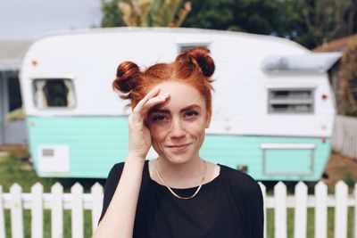 Portrait of smiling woman with trailer