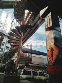 Low angle view of road sign against sky