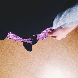 Close-up of woman standing against black background