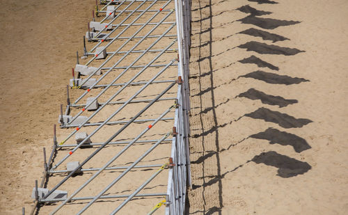 High angle view of ladder on railing during sunny day
