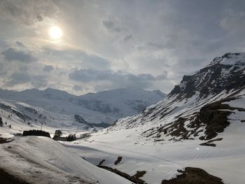 Scenic view of snow covered mountains against sky