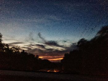 Scenic view of silhouette landscape against sky at night