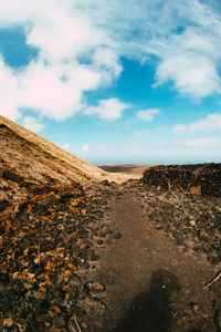 Scenic view of desert land against sky