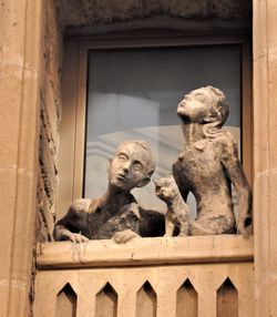 Low angle view of statue against historic building