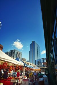 Buildings in city against blue sky