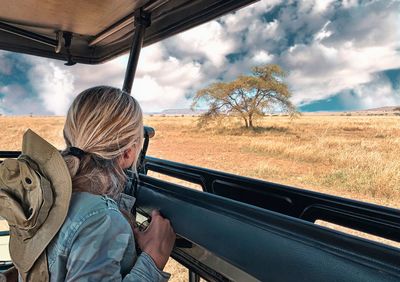 Woman standing in jeep