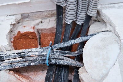 Old electrical cables in brick wall. danger wiring