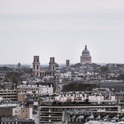 View of buildings in city against clear sky