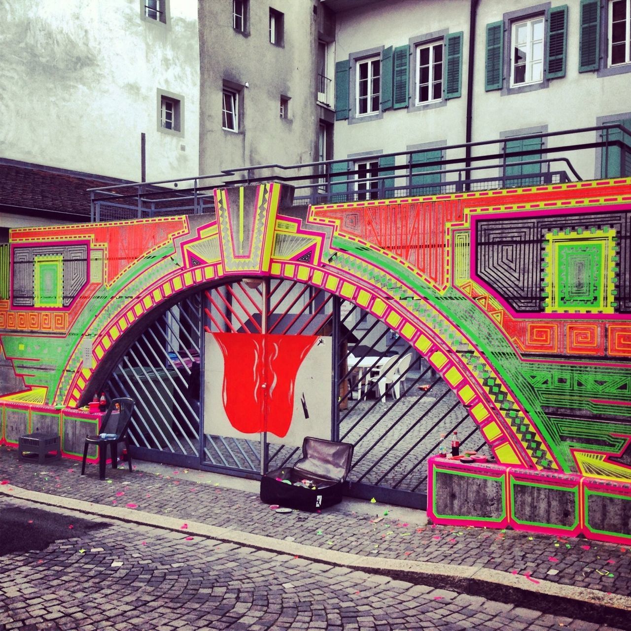 architecture, built structure, building exterior, arch, red, multi colored, graffiti, city, art and craft, building, art, cobblestone, day, street, outdoors, railing, wall - building feature, creativity, entrance, steps
