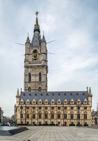 Low angle view of clock tower against sky