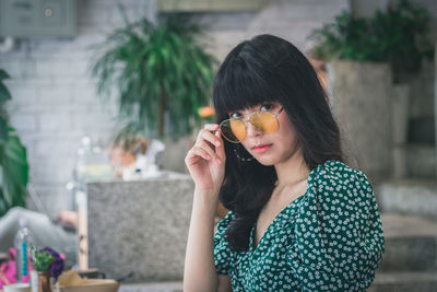 Portrait of beautiful young woman wearing sunglasses 