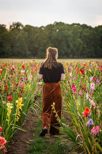 Rear view of woman standing on field