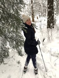 Portrait of smiling woman on snow field during winter