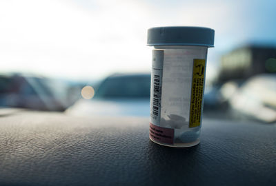 Close-up of pill bottle in car