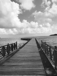 Pier over sea against sky