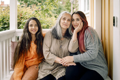 Portrait of multi-generation family sitting together at porch