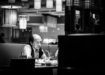 Portrait of man eating food in restaurant