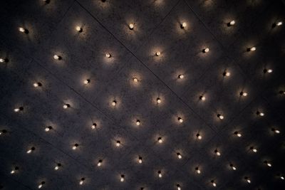 Low angle view of illuminated lights on ceiling