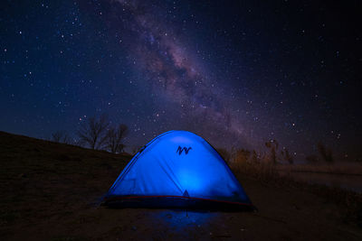 Tent on field against sky at night