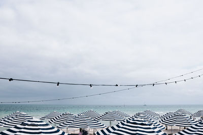 White and blue umbrellas close to the sea in adelaide