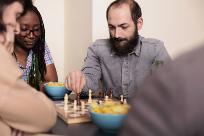 Business colleagues playing chess at home