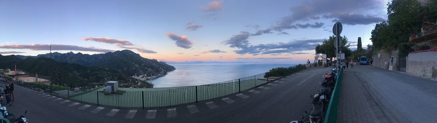 Panoramic view of road by sea against sky