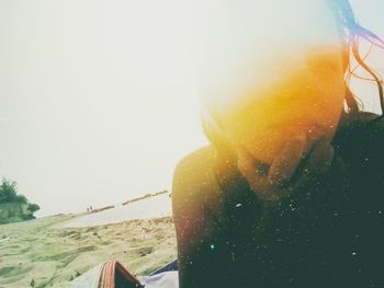 Close-up of man on beach against sky