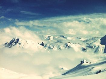 Scenic view of snow covered mountains against sky