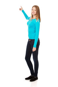 Portrait of young woman standing against white background