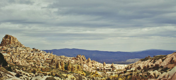 Cappadocia and mountains against cloudy sky