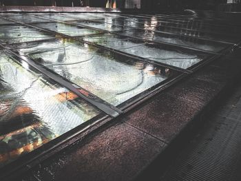 High angle view of railroad tracks seen through glass