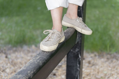 Low section of man standing on grass