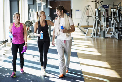 Friends conversing while walking at health club