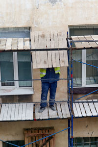 Low section of man standing in front of building