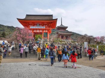 People at temple against sky