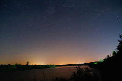 Scenic view of landscape against sky at night