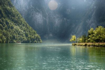 Scenic view of lake in forest against sky