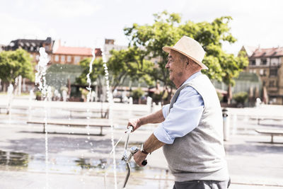 Smiling senior man with folding bicycle