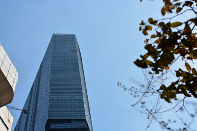 Low angle view of modern buildings against clear blue sky